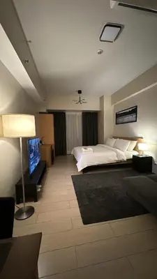 a bedroom with a bed and a tv in it at 81 Newport Blvd Cluster 5 Unit 4E by Rechelle Nunag in Manila