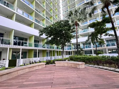 a walkway in front of a large apartment building at Azure Staycation Condo Unit in Manila