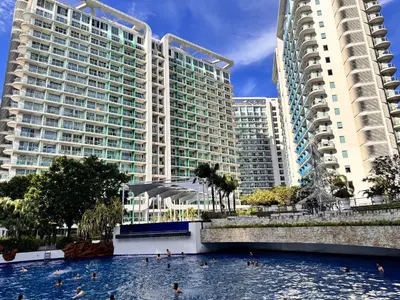 a swimming pool in front of two tall buildings at Azure Staycation Condo Unit in Manila