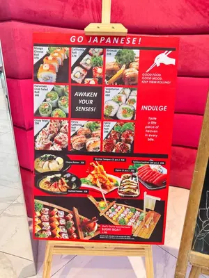 a sign for a restaurant with different types of food at Azure Staycation Condo Unit in Manila