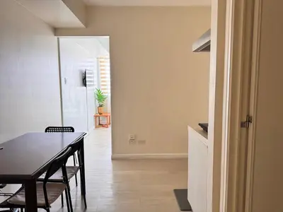 a dining room with a black table and chairs at Azure Staycation Condo Unit in Manila