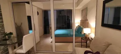 a living room with a blue couch in a room at Azure Cozy Vibe Condo Unit in Manila