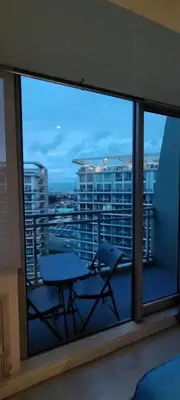 a balcony with a table and a view of a city at Azure Cozy Vibe Condo Unit in Manila