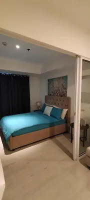 a bedroom with a blue bed in a room at Azure Cozy Vibe Condo Unit in Manila