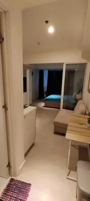a living room with a couch and a bed at Azure Cozy Vibe Condo Unit in Manila