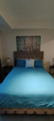 a bedroom with a blue bed with blue pillows at Azure Cozy Vibe Condo Unit in Manila
