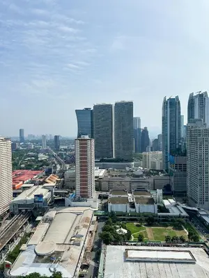an aerial view of a city with tall buildings at Cozy Mid-Century Condo with a Skyline View in Manila