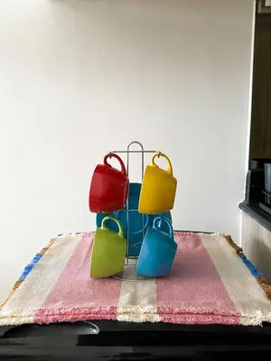 three colored buckets sitting on top of a table at Cozy Mid-Century Condo with a Skyline View in Manila