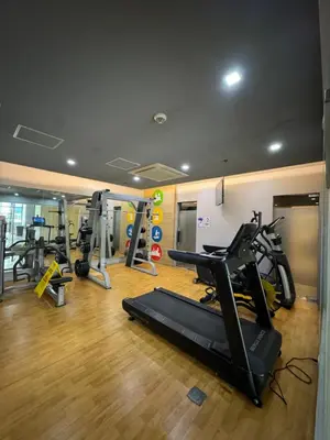 a gym with several treadmills and exercise bikes at Alaya Place - Palm Tree II - in front of NAIA 3 in Manila