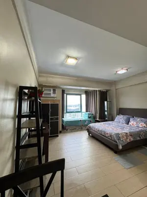 a bedroom with a bed and a ladder in it at Alaya Place - Palm Tree II - in front of NAIA 3 in Manila