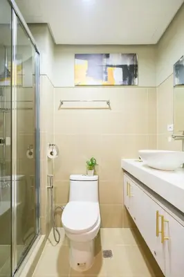 a bathroom with a toilet and a sink and a shower at Luxe 1BR with WiFi, Karaoke and Balcony Near SM Megamall in Manila