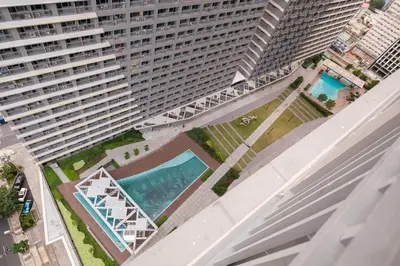 an aerial view of a large apartment building with a pool at Luxe 1BR with WiFi, Karaoke and Balcony Near SM Megamall in Manila