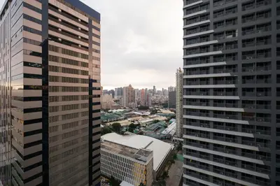 a view of the city from a skyscraper at Luxe 1BR with WiFi, Karaoke and Balcony Near SM Megamall in Manila