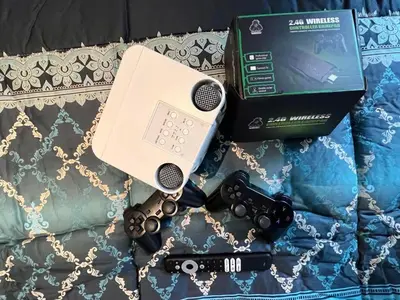 a nintendo wii game system and a box on a bed at Staycation in Azure Paranaque in Manila