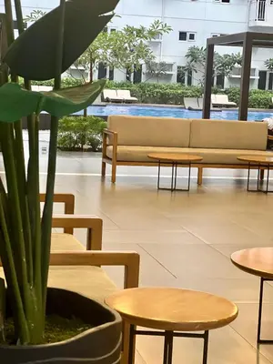 a room with tables and a couch and a plant at FRIENDS TV Staycation in Manila