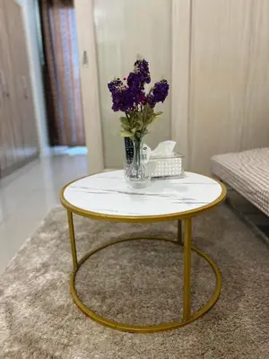 a yellow and white table with a vase of flowers on it at JAZZ RESIDENCES- Amaya Stays in Manila