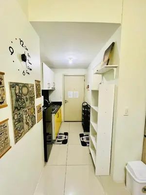 a kitchen with a stove top oven in a room at JAZZ RESIDENCES- Amaya Stays in Manila