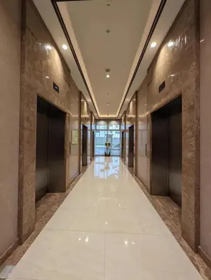 an empty hallway of a building with two doors at Holiday suite at Park Mckinley West in Manila