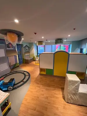 a living room with a play room with a toy house at Gentry Manor Near MOA&Airport WiFi TV Netflix Okada view 6Q in Manila