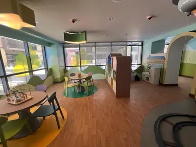 a living room with a table and chairs and a dining room at Gentry Manor Near MOA&Airport WiFi TV Netflix Okada view 6Q in Manila
