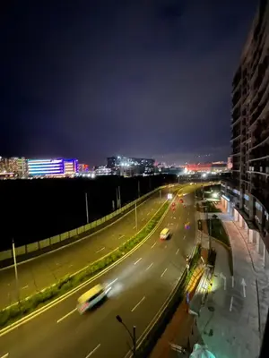 a city street at night with cars on the road at Gentry Manor Near MOA&Airport WiFi TV Netflix Okada view 6Q in Manila