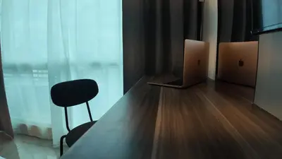 a room with a table and a chair and a laptop at Sky Suite Makati Modern Penthouse near Greenbelt in Manila