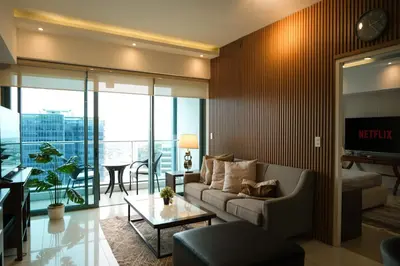 a living room with a couch and a table at One Uptown Premium 2BR Suite in Manila