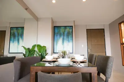 a dining room with a table and chairs at One Uptown Premium 2BR Suite in Manila