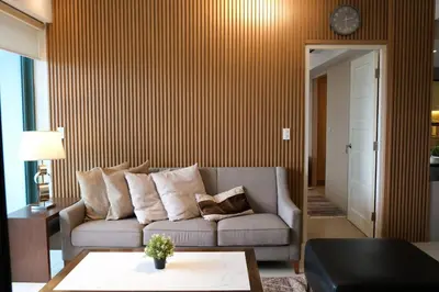 a living room with a couch and a table at One Uptown Premium 2BR Suite in Manila