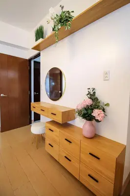 a room with a wooden dresser and a mirror at Cylo's Place Manhattan in Manila