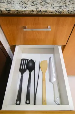 a drawer with utensils in a kitchen at Cylo's Place Manhattan in Manila