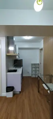 an empty room with a kitchen and a table at Azure Family Room Condo Unit in Manila