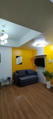 a living room with a couch and a tv at Azure Family Room Condo Unit in Manila