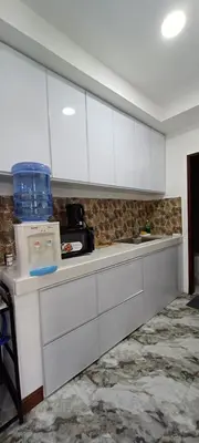 a kitchen with white cabinets and a counter top at Family Unit at Mary's Staycation in Tanza Cavite Condo Type good for 4 person in Tanza
