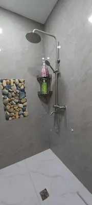 a shower with a shower head and a shower at Family Unit at Mary's Staycation in Tanza Cavite Condo Type good for 4 person in Tanza