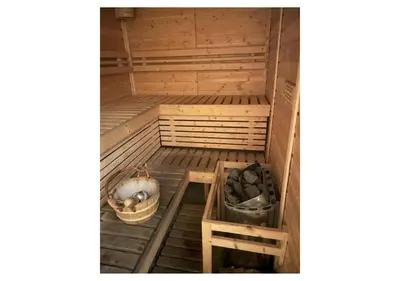 an empty wooden sauna with two tiers at The Bay Nest in Manila