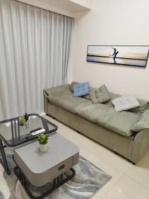 a living room with a couch and a table at Savvy Suite 1BR near Okada in Manila