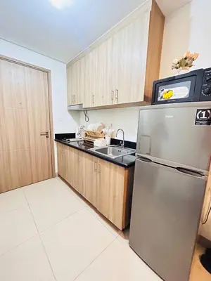 a kitchen with a stainless steel refrigerator and a sink at La Chicka Staycation -1292 in Manila