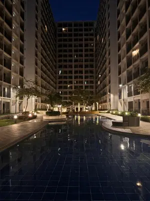 a pool in the middle of a city at night at La Chicka Staycation -1292 in Manila