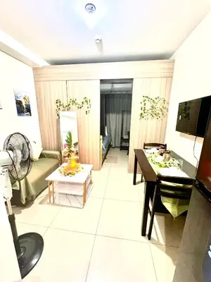 a living room with a couch and a table at La Chicka staycation in Manila
