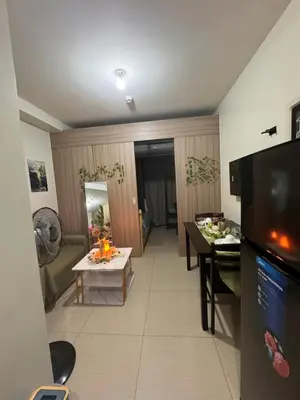 a room with a kitchen and a living room at La Chicka staycation in Manila