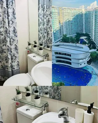 a bathroom with two toilets and a sink with a cruise ship at Uno Tahanan Azure in Manila
