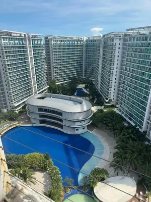 a large building in front of some tall buildings at Uno Tahanan Azure in Manila