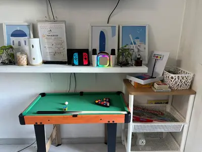 a desk with a green ping pong table on it at Uno Tahanan Azure in Manila