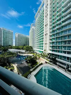 a view of a large apartment building with a swimming pool at Staycation in Azure Paranaque in Manila