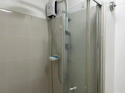 a shower with a shower head in a bathroom at 1-Br Unit at Light Residences in Manila