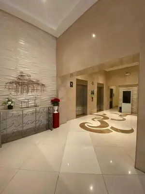 a large lobby with a large room with a symbol on the floor at JNL Condotel in Manila