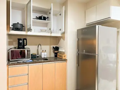 a kitchen with a stainless steel refrigerator and cabinets at Prime 1br Condo Infront Grand Hyatt BGC #oursw20d1 in Manila