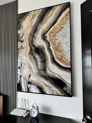 a painting hanging on a wall above a desk at Condo in Malate in Manila
