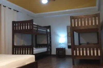 a room with two bunk beds and a lamp at Villa Ariana Family Getaway in Bukal